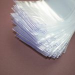 A lot of small disposable plastic bags with zip fastener on a dark background. View from above